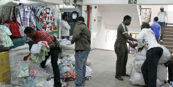 African traders buy clothes at a shop in Guangzhou, China